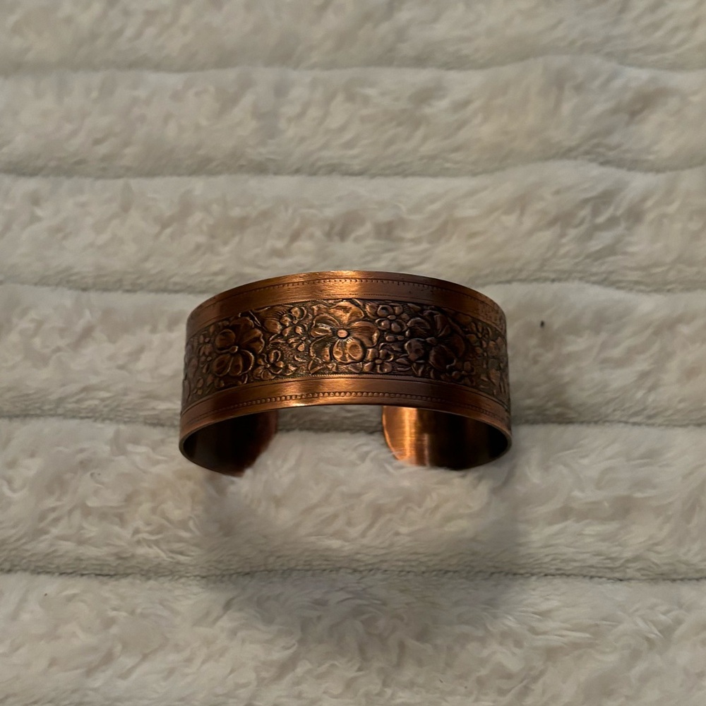 Copper colored cuff bracelet.